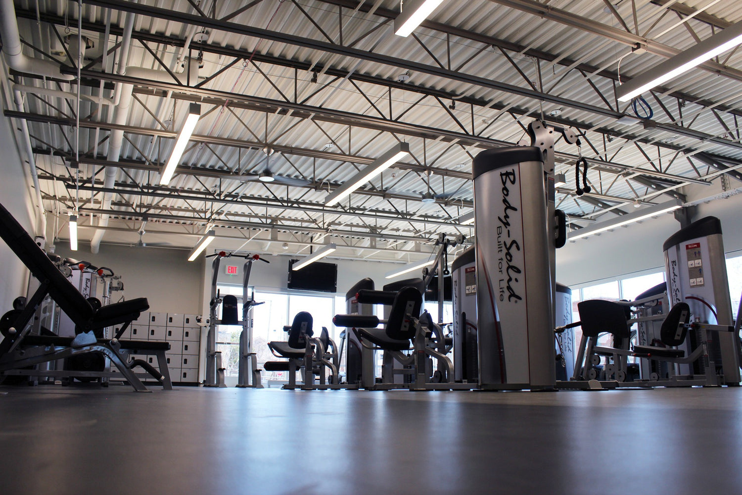 Gym interior with exercise equipment and 'Body Solid' branding.