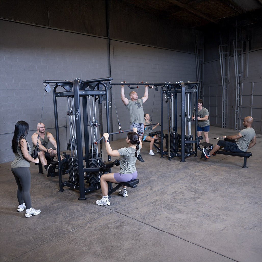 Group of people exercising in a gym with various equipment.