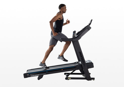 Man running on a treadmill with a white background