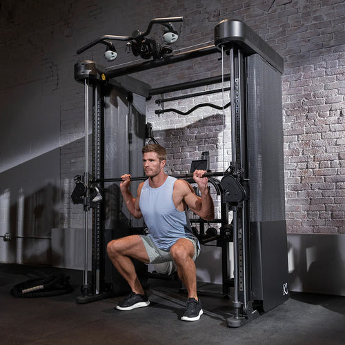 Man exercising on a cable machine in a gym setting