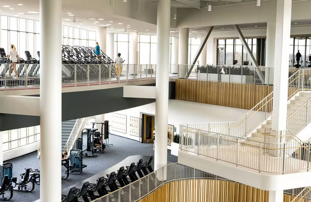 The Matrix office. Modern indoor space with high ceilings, large windows, and a staircase.