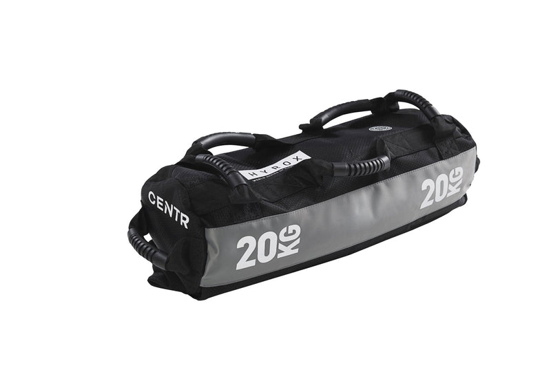 A black and gray Centr x Hyrox Competition Sandbag with a label showing '20kg'.