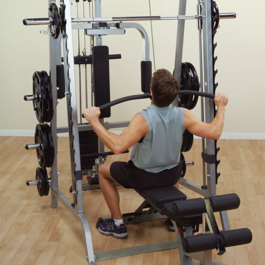 Person using a weight machine in a gym setting