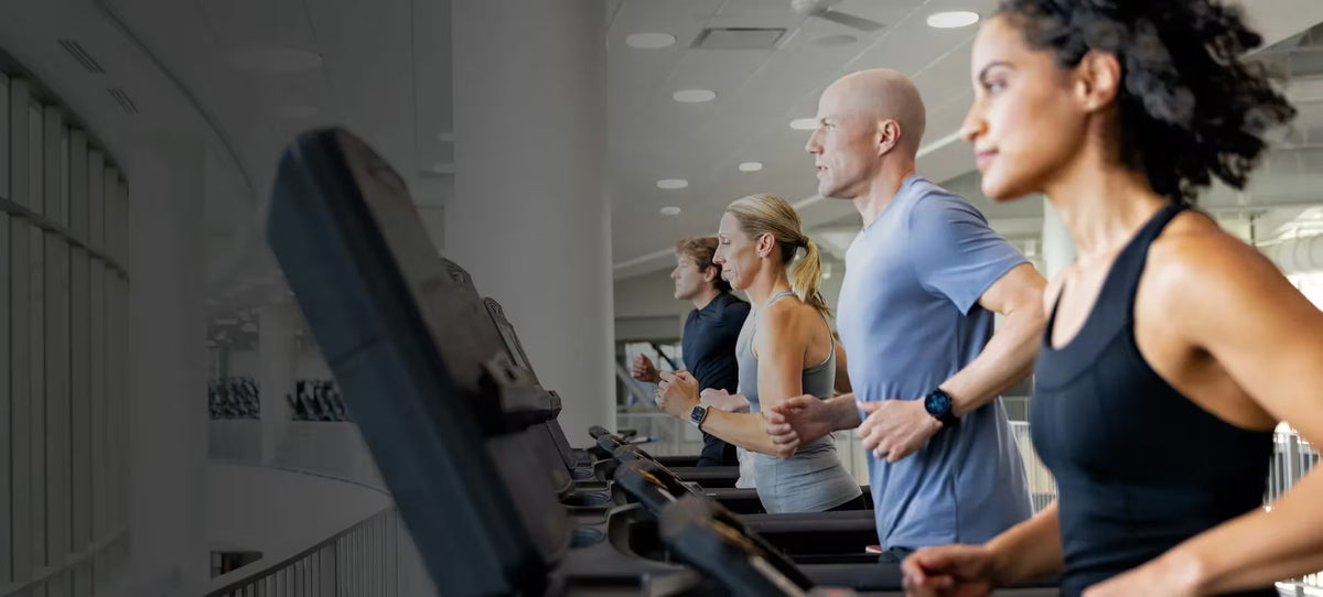 People using treadmills in a gym setting
