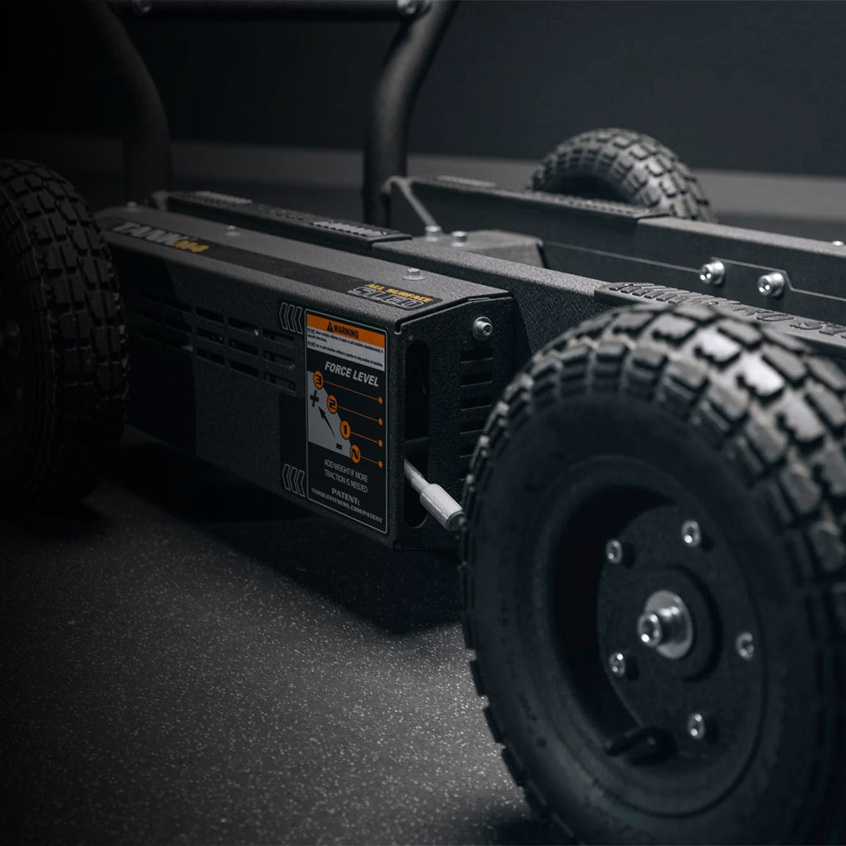 Close-up of a black Troque tank M4 with visible branding on a dark background