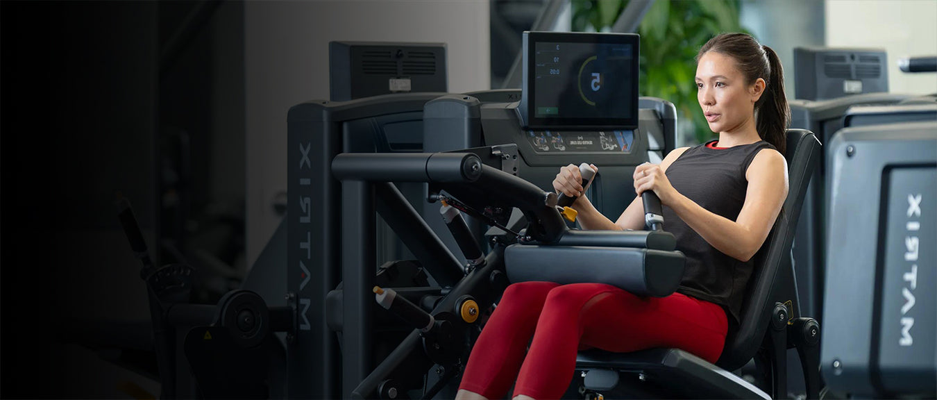 Woman using a piece of exercise equipment in a gym setting