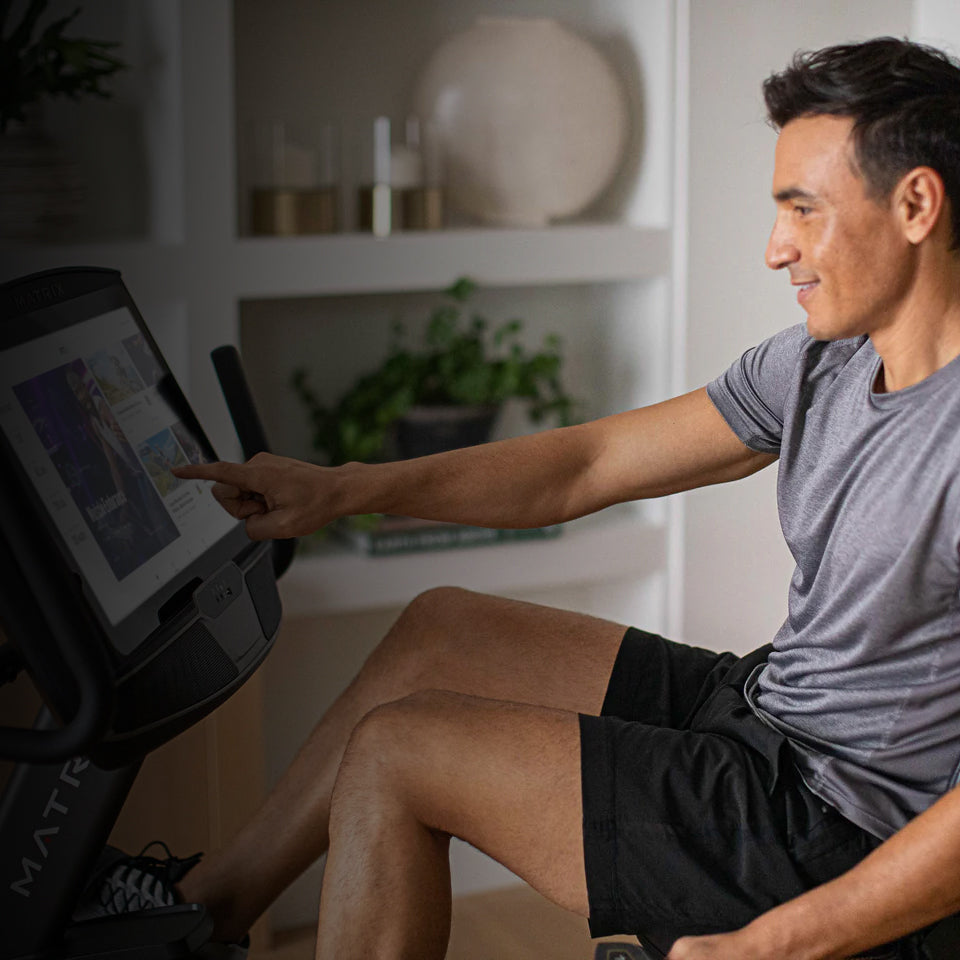 Man using a cycling machine in a home setting