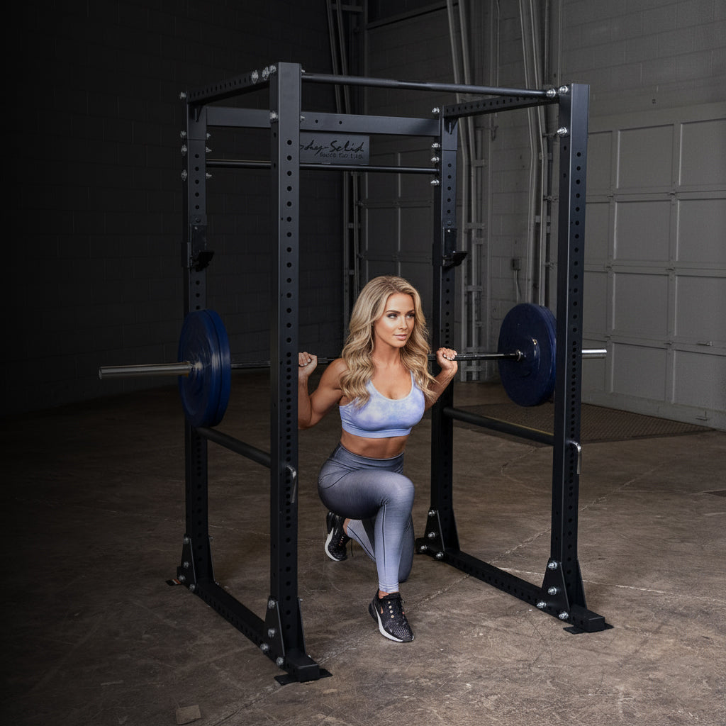 Woman exercising with a Body-Solid power rack in a gym setting