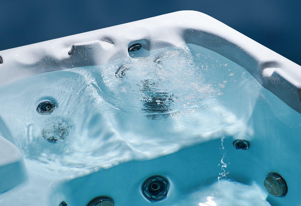 Hot tub with water and bubbles against a blue background
