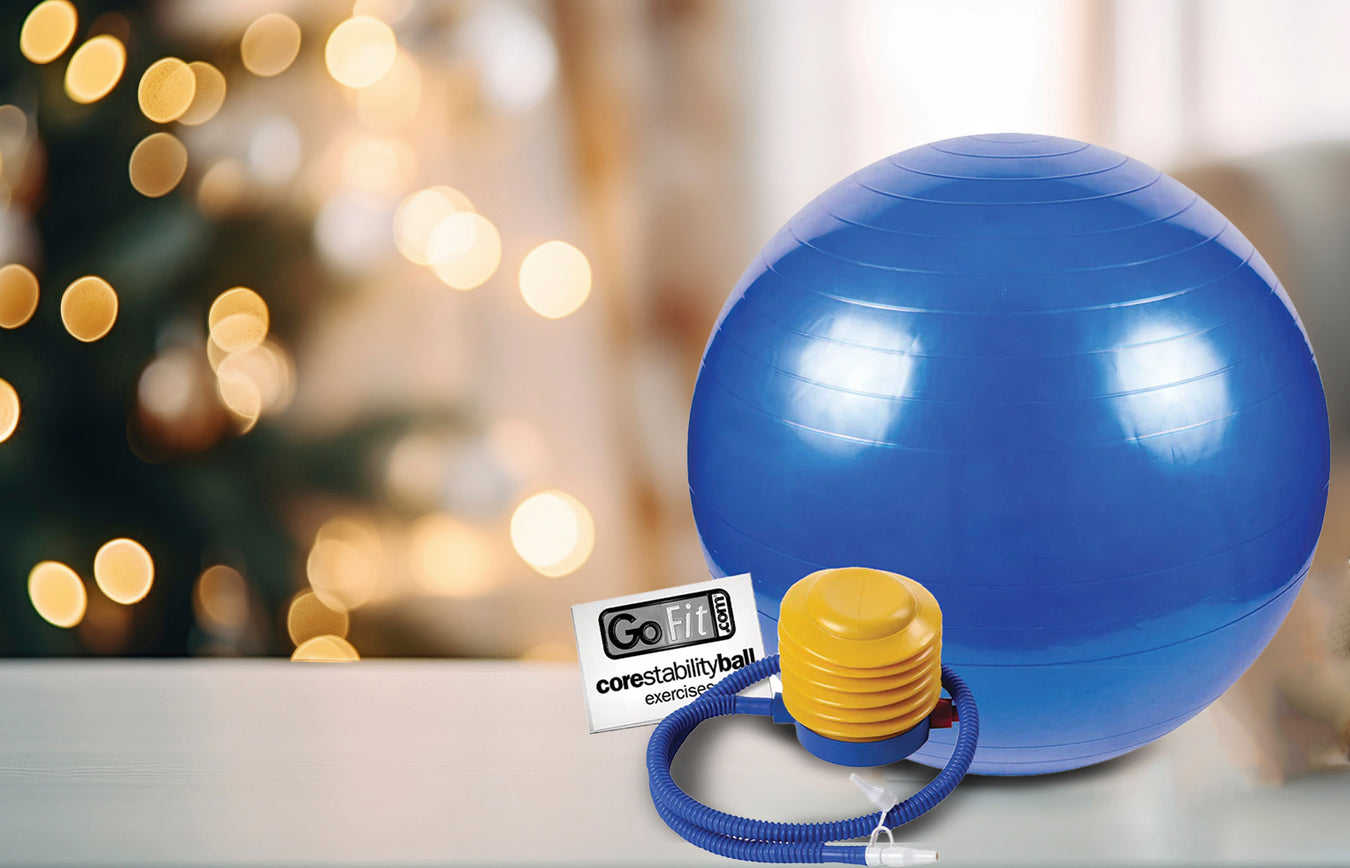Blue exercise ball with a yellow core stability bar on a blurred festive background