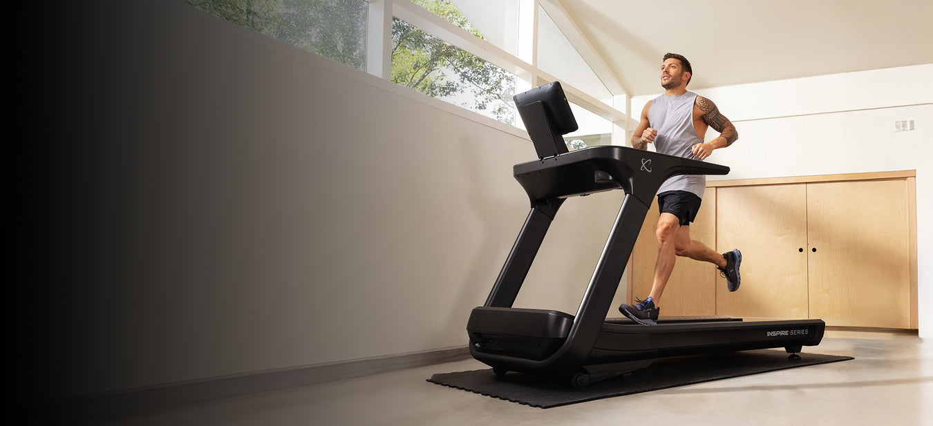 Man running on a treadmill in a modern indoor setting