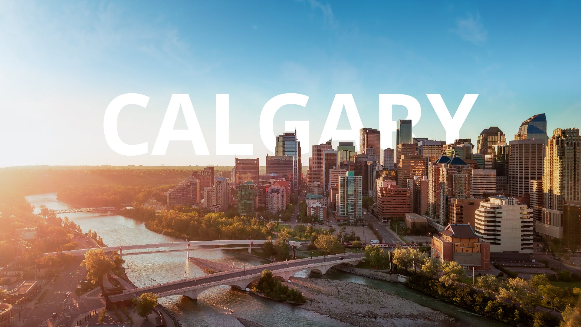 City skyline with the word 'Calgary' overlayed on a clear day.