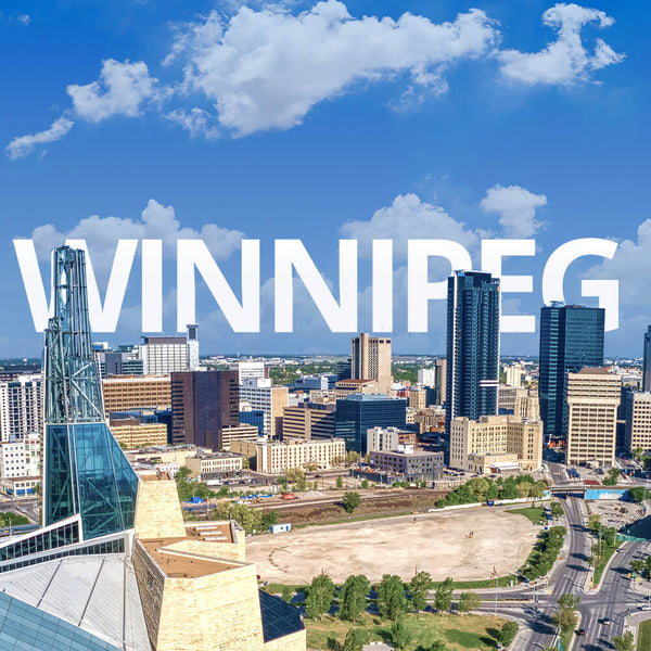Cityscape of Winnipeg with prominent buildings and clear blue sky.