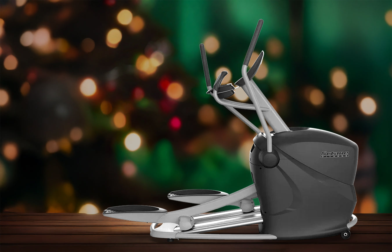 Elliptical trainer on a wooden surface with a blurred festive background