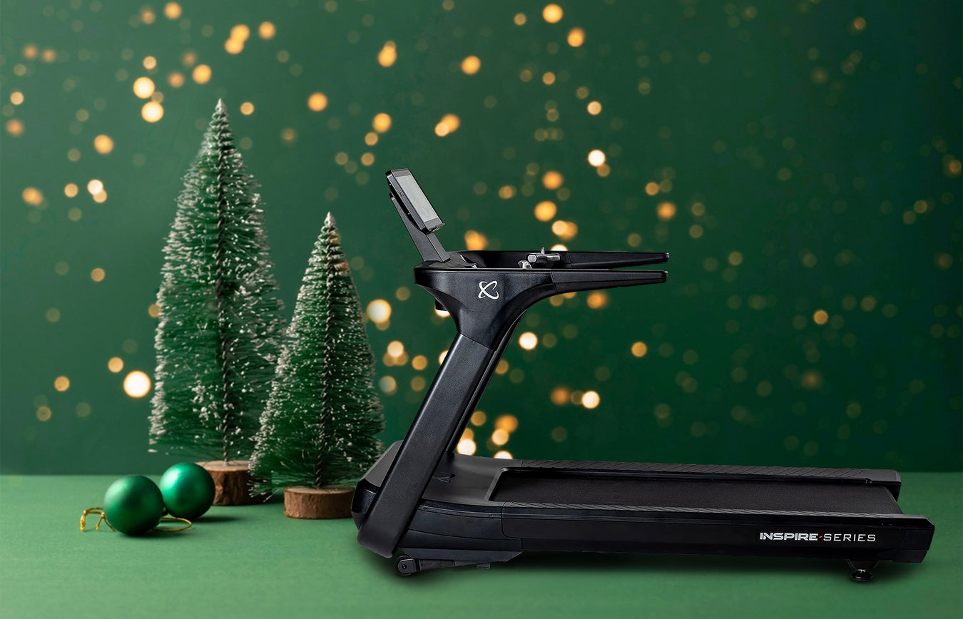 Black treadmill with Christmas trees and decorations on a green background