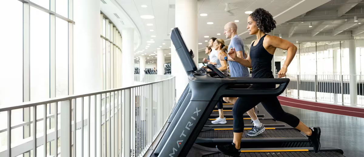 Woman running on a treadmill in a modern indoor setting