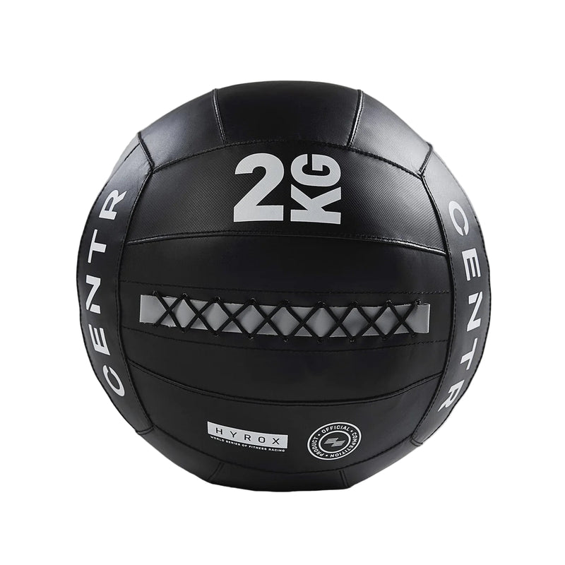 Black exercise ball with '2 KG' marking on a gray background