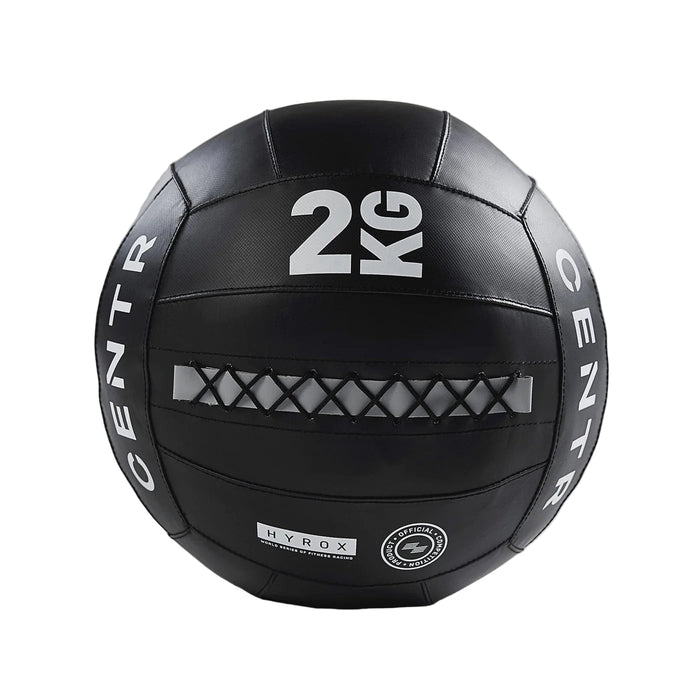 Black exercise ball with '2 KG' marking on a gray background