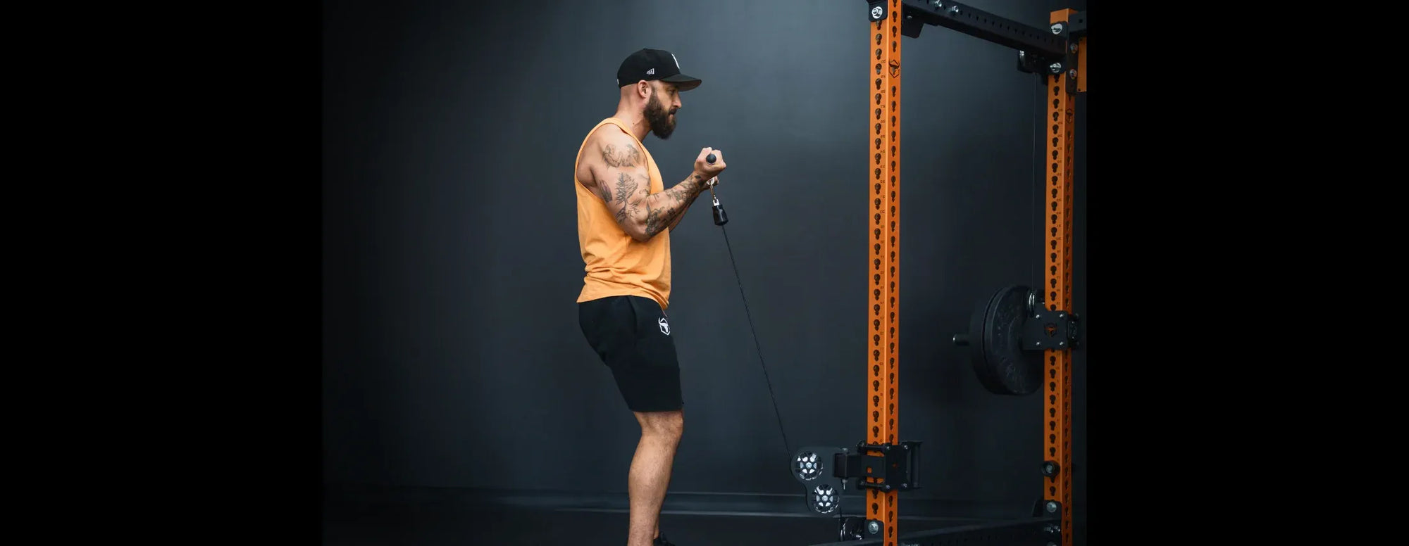 Man using a cable machine in a gym setting