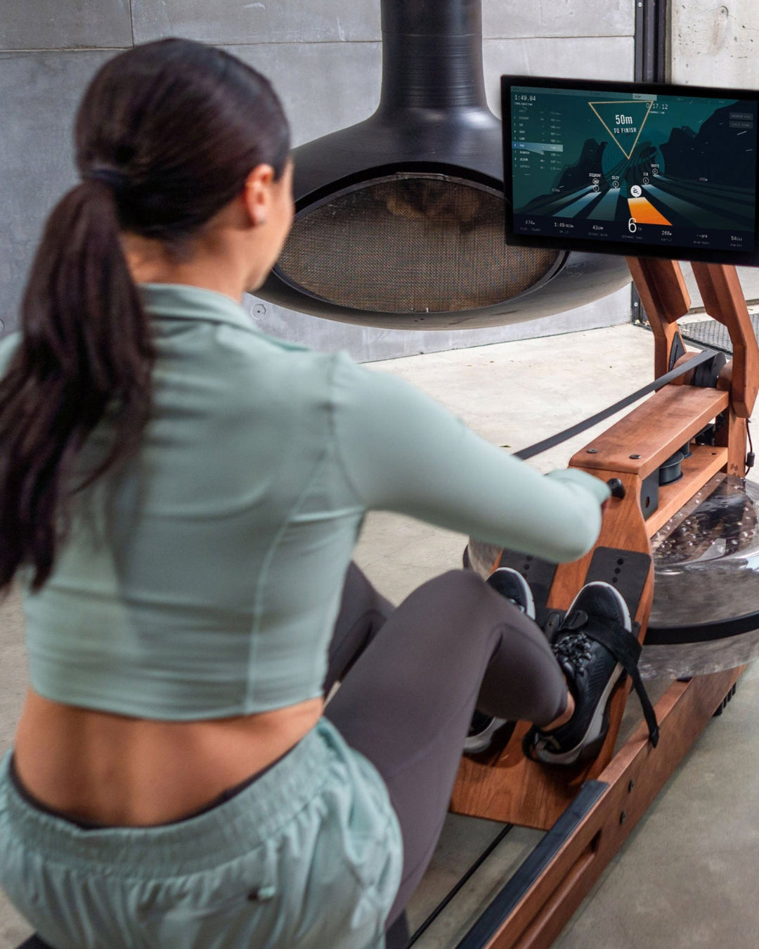 Two people in a modern living room with a television screen displaying a video game.