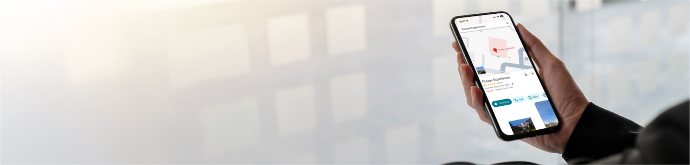 A man holding the phone check the location of Fitness Experience store